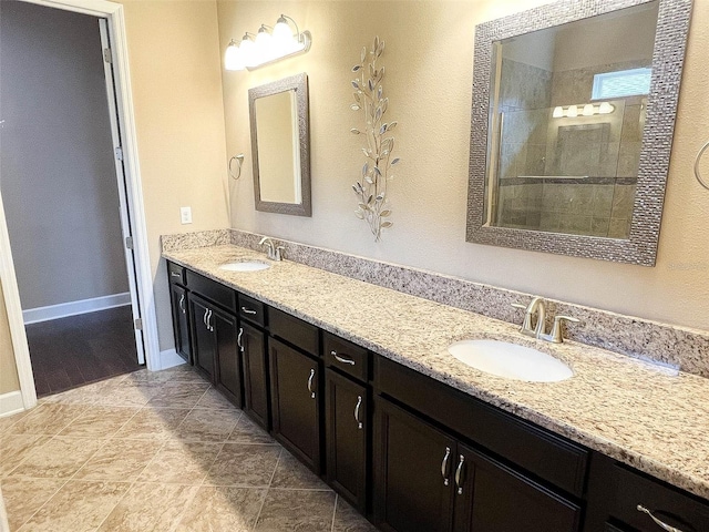 bathroom with vanity and tiled shower