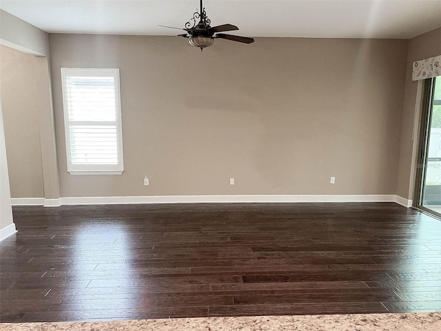 empty room with dark hardwood / wood-style floors and ceiling fan