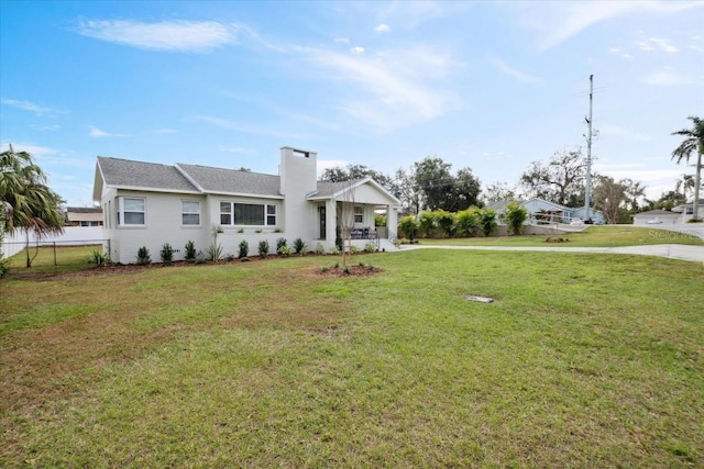 view of front of home with a front yard and covered porch