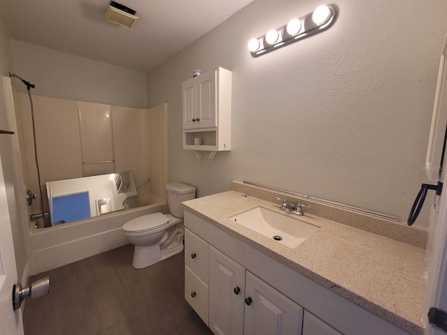 full bathroom with hardwood / wood-style flooring, bathing tub / shower combination, vanity, and toilet