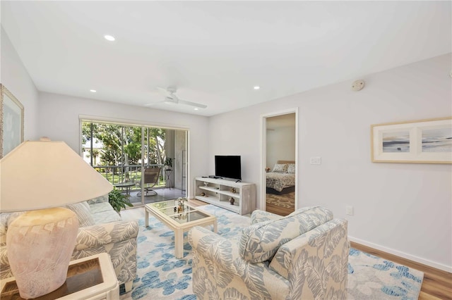 living room featuring ceiling fan and wood-type flooring