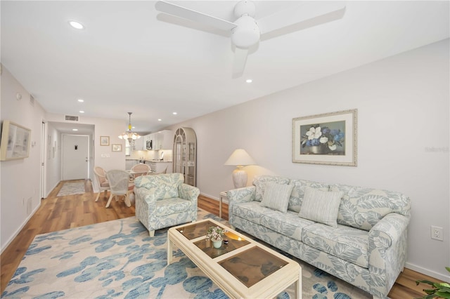 living room featuring ceiling fan and wood-type flooring