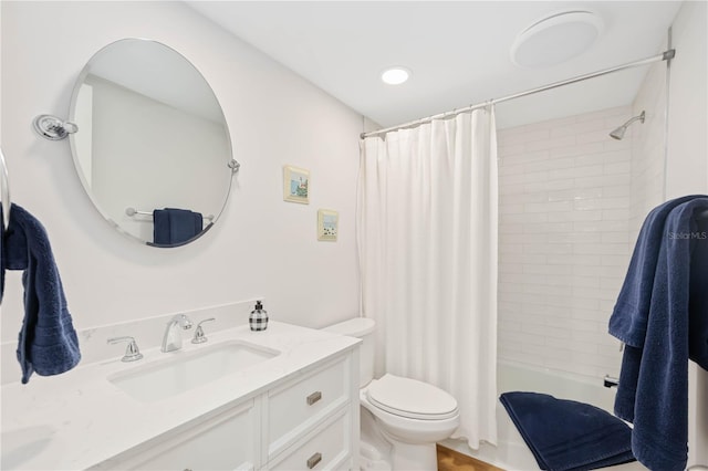 full bathroom featuring shower / bath combo, vanity, and toilet