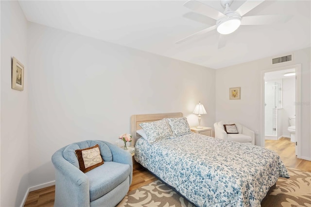 bedroom featuring ceiling fan, light wood-type flooring, and connected bathroom