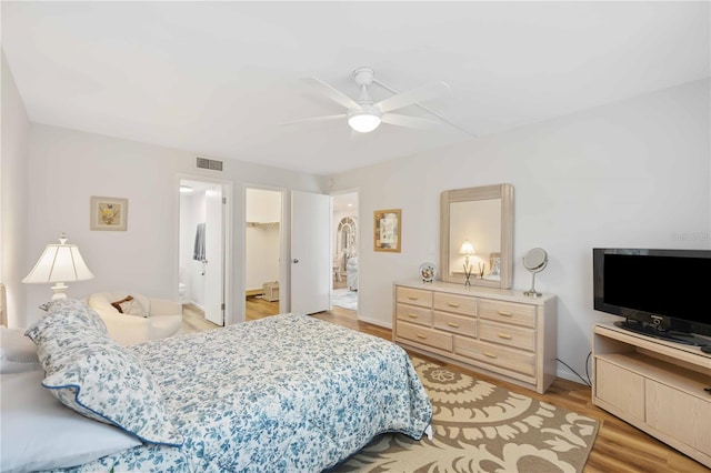 bedroom featuring ensuite bath, ceiling fan, a spacious closet, light hardwood / wood-style flooring, and a closet