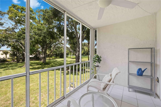 unfurnished sunroom featuring ceiling fan