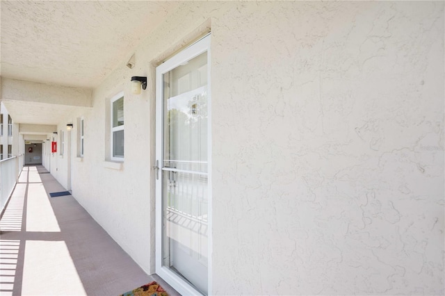 view of exterior entry featuring a balcony