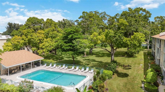 view of swimming pool featuring a yard and a patio