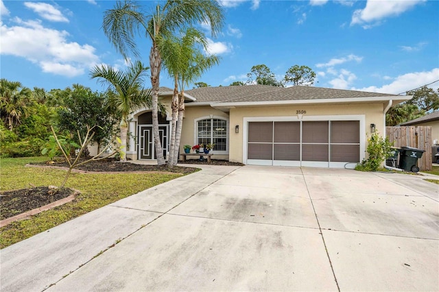 ranch-style house featuring a garage and a front lawn