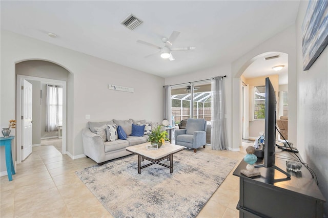 living room featuring light tile patterned floors and ceiling fan