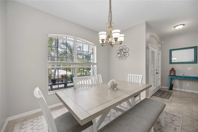 dining room featuring french doors, an inviting chandelier, and light tile patterned flooring