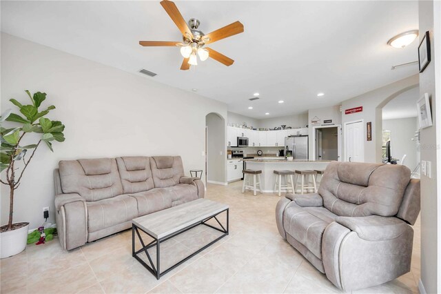 tiled living room featuring ceiling fan