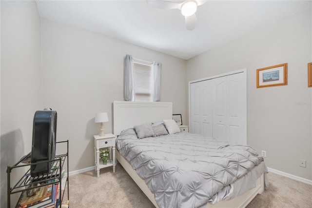 bedroom with a closet, light colored carpet, and ceiling fan