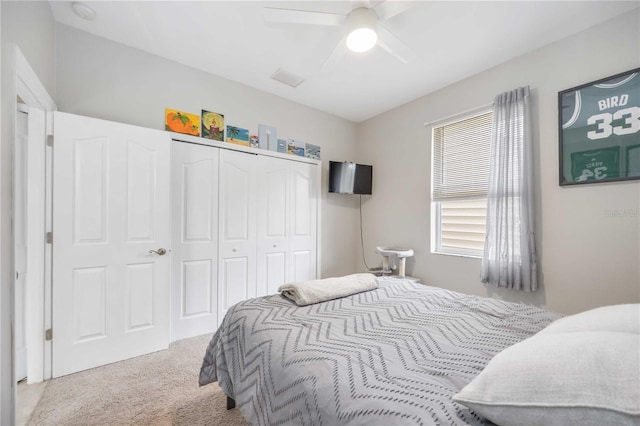 carpeted bedroom with a closet and ceiling fan