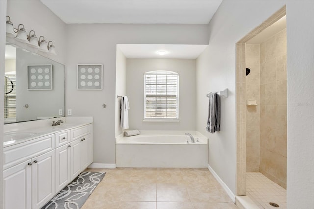 bathroom featuring tile patterned floors, vanity, and shower with separate bathtub