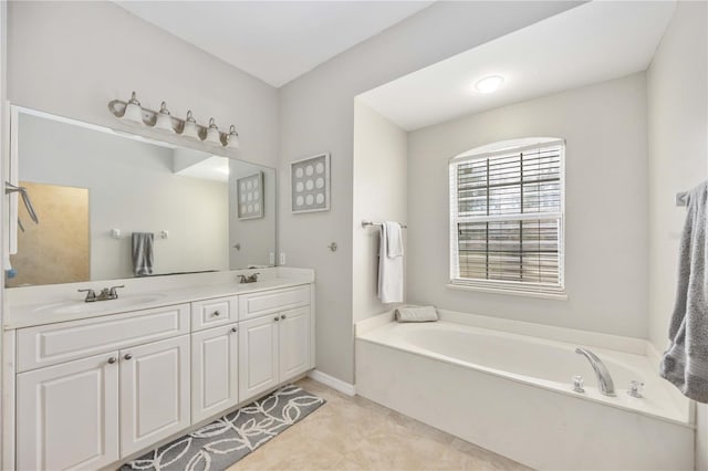 bathroom featuring a washtub, vanity, and tile patterned floors