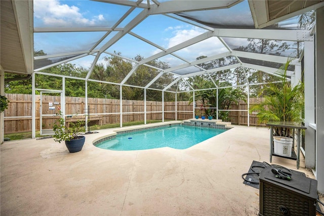 view of swimming pool featuring a patio area and a lanai