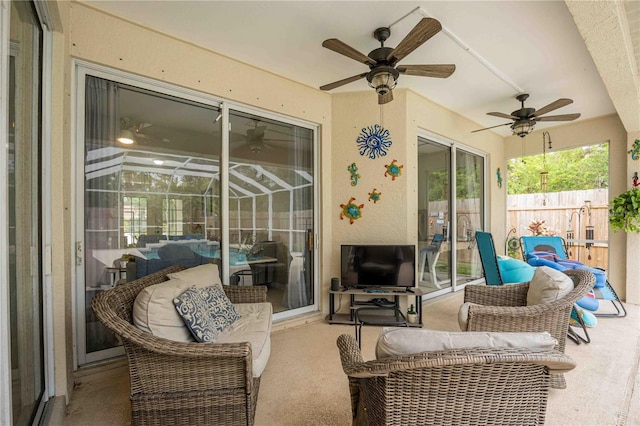 sunroom / solarium featuring ceiling fan