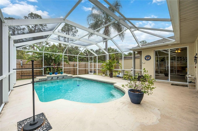 view of swimming pool featuring a patio and a lanai