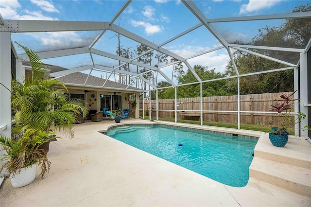 view of pool with a lanai, a patio area, and ceiling fan