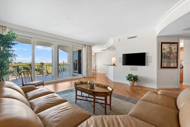 living room with crown molding and light wood-type flooring