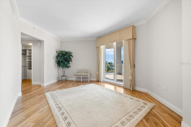 living area with light wood-type flooring and ornamental molding