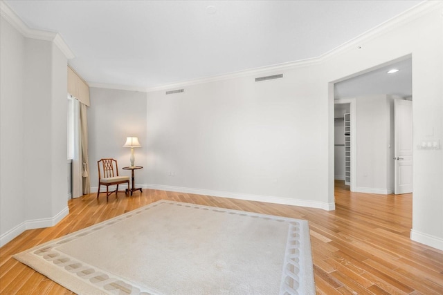 unfurnished room with wood-type flooring and crown molding