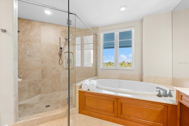 bathroom featuring vanity and shower with separate bathtub