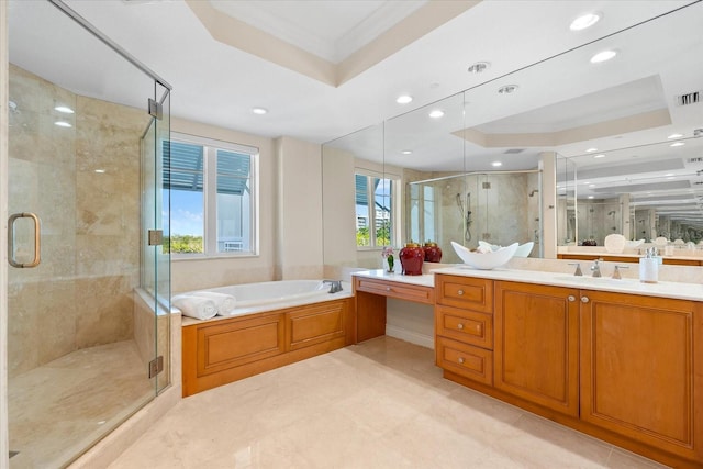 bathroom with a tray ceiling, a wealth of natural light, vanity, and shower with separate bathtub