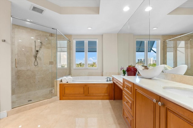 bathroom with vanity, a healthy amount of sunlight, and shower with separate bathtub