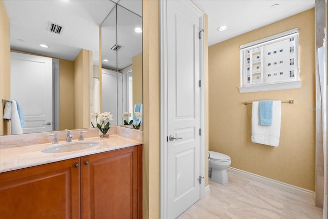 bathroom with vanity and toilet