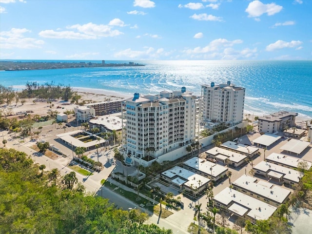 drone / aerial view featuring a water view and a view of the beach