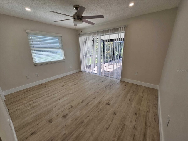 unfurnished room featuring ceiling fan, a textured ceiling, and light hardwood / wood-style flooring