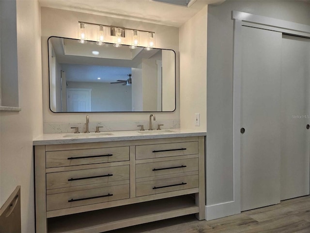 bathroom with hardwood / wood-style flooring, vanity, and ceiling fan