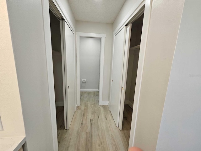 hall with light hardwood / wood-style flooring