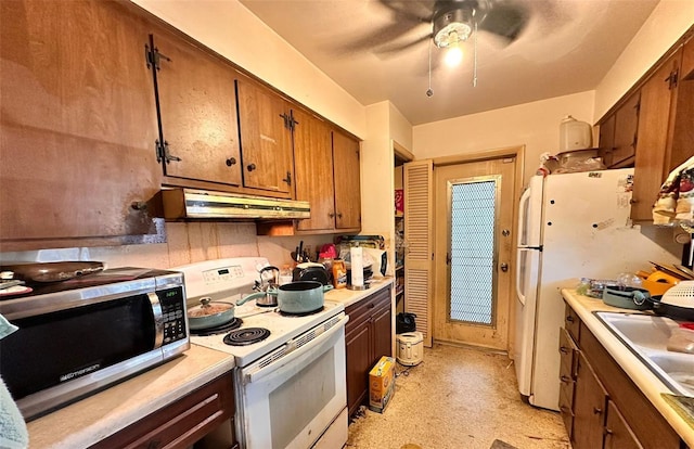 kitchen featuring white appliances, ceiling fan, and sink