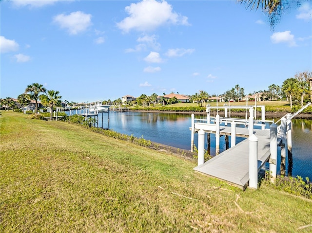 view of dock with a water view and a lawn