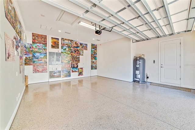 garage featuring a garage door opener and water heater