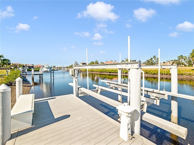 dock area with a water view and boat lift