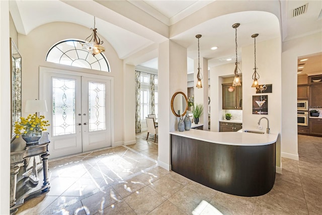 entryway with visible vents, baseboards, a notable chandelier, and french doors