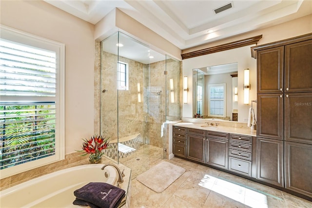 bathroom featuring a bath, a stall shower, vanity, and visible vents