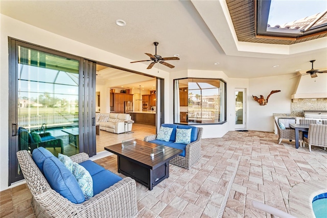 view of patio featuring exterior kitchen, ceiling fan, and an outdoor hangout area