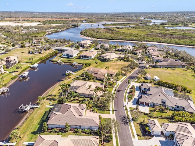 drone / aerial view with a water view and a residential view