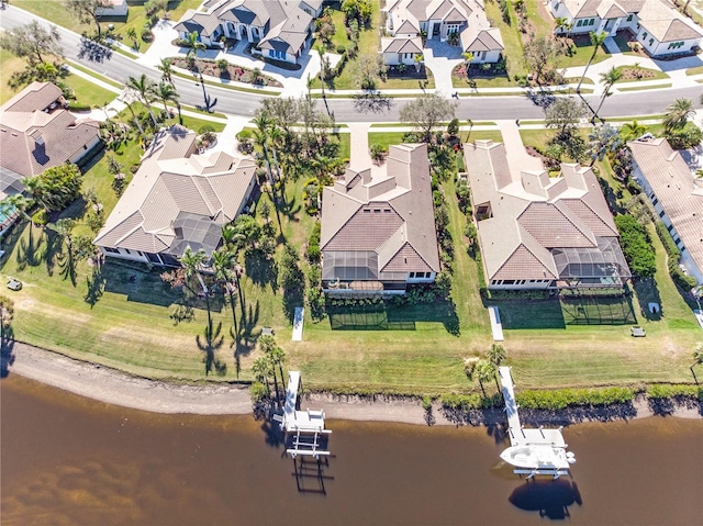 birds eye view of property featuring a water view and a residential view