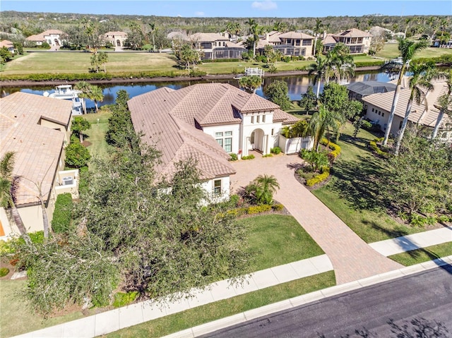 drone / aerial view with a water view and a residential view