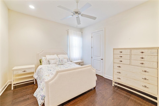 bedroom featuring ceiling fan, baseboards, and dark wood-type flooring