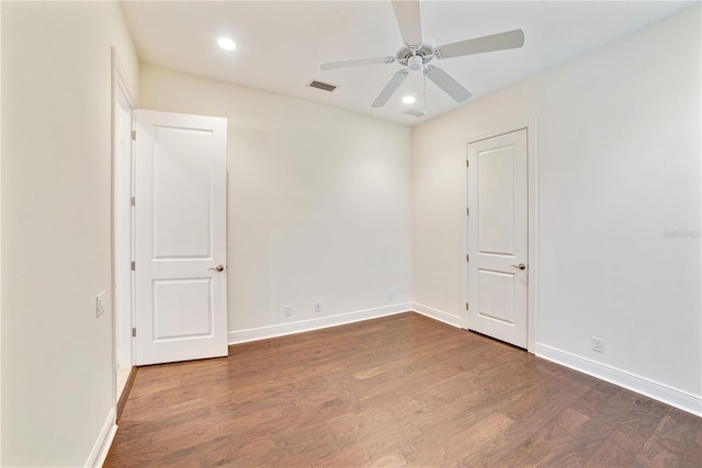 unfurnished room with visible vents, baseboards, and wood finished floors