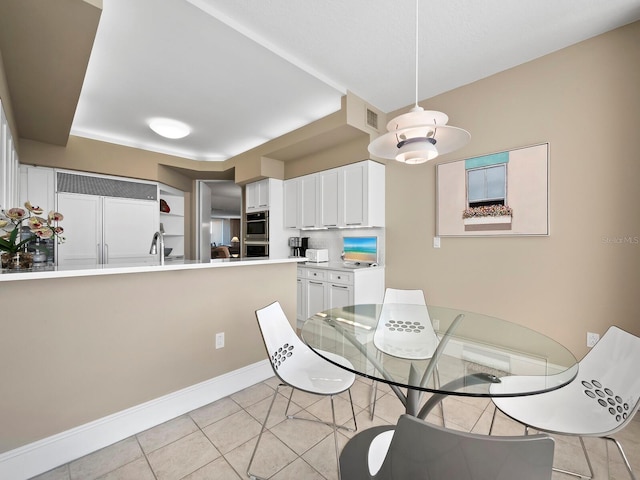 dining room featuring light tile patterned floors, baseboards, and visible vents