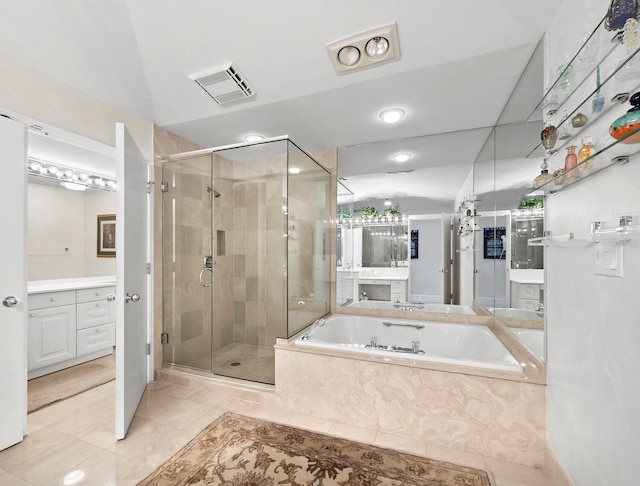 bathroom featuring a stall shower, visible vents, a garden tub, and vanity