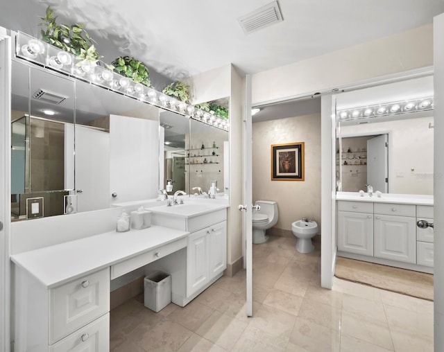 bathroom with a bidet, vanity, and visible vents